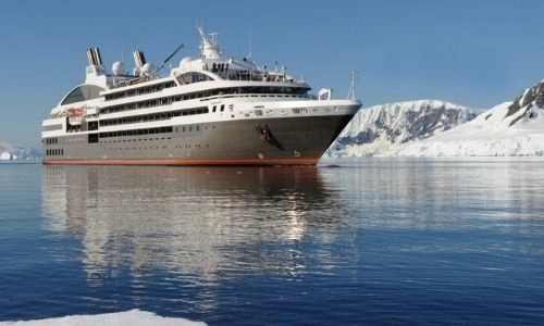 bateau de croisi&egrave;re ponant sur l'eau entour&eacute; de glacier
