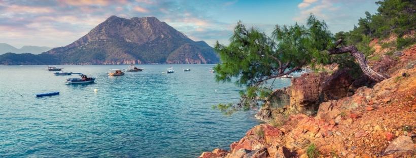 Petits bateaux sur la mer Méditerranée devant une montagne